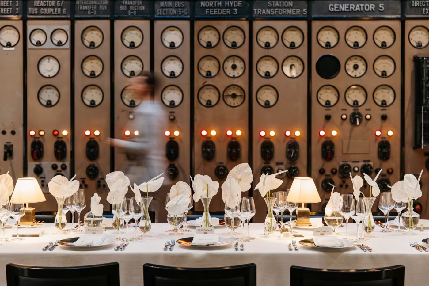 Battersea Power Station event space with elegant dining setup and industrial control panels